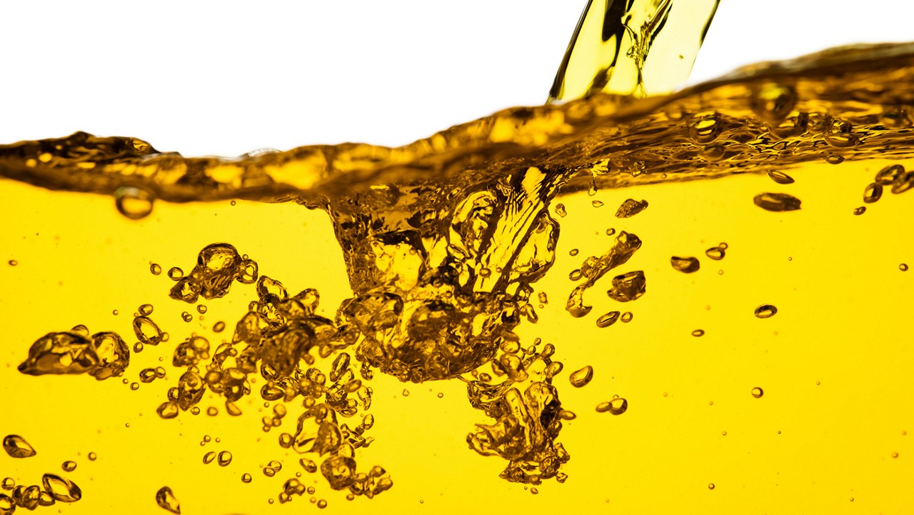 A close-up view of a car fluid being poured.