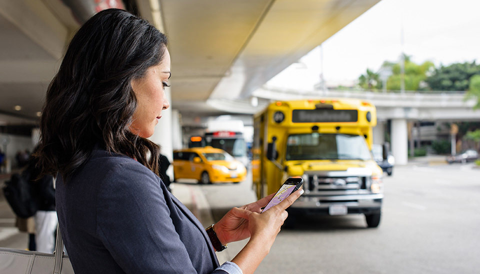 Woman using the parking spot app at the airport