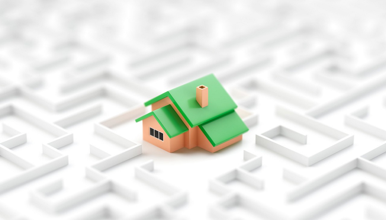 Small toy house in the middle of endless white maze