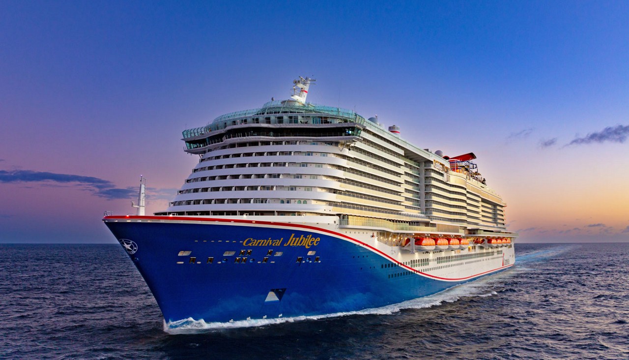 Carnival Jubilee ship in ocean waters at sunset