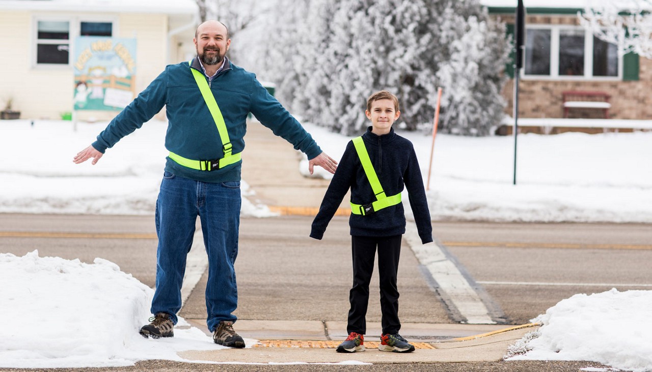 Father and son posing in their school safety patrol belts
